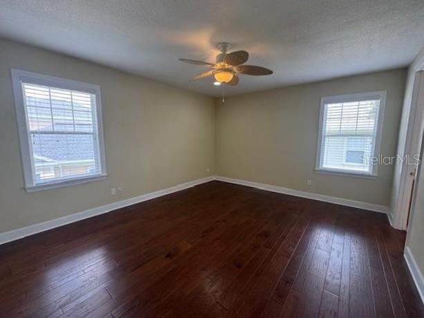 1442 Stickley Avenue Celebration, FL 34747 - Photo 18 of 46 a view of an empty room with wooden floor and a window