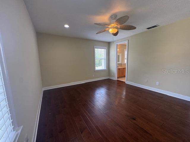 1442 Stickley Avenue Celebration, FL 34747 - Photo 19 of 46 a view of an empty room with wooden floor and a window