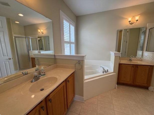 1442 Stickley Avenue Celebration, FL 34747 - Photo 21 of 46 a bathroom with a tub a sink double vanity and a mirror