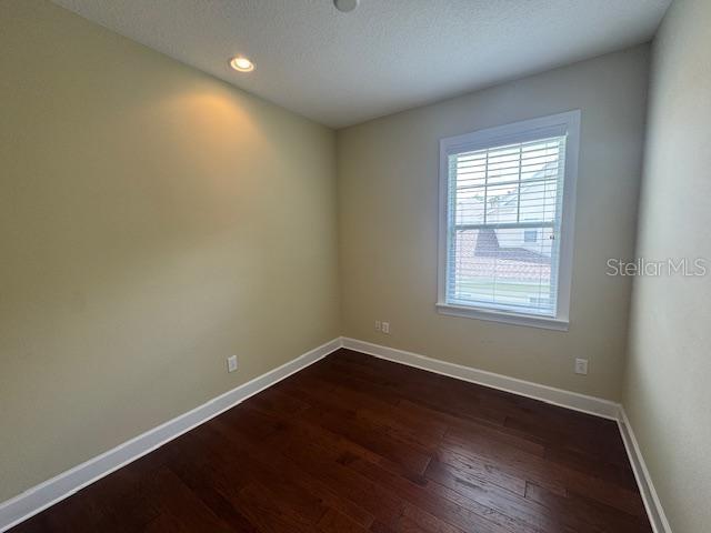 1442 Stickley Avenue Celebration, FL 34747 - Photo 26 of 46 an empty room with wooden floor and windows