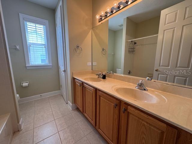 1442 Stickley Avenue Celebration, FL 34747 - Photo 28 of 46 a bathroom with a double vanity sink a and mirror