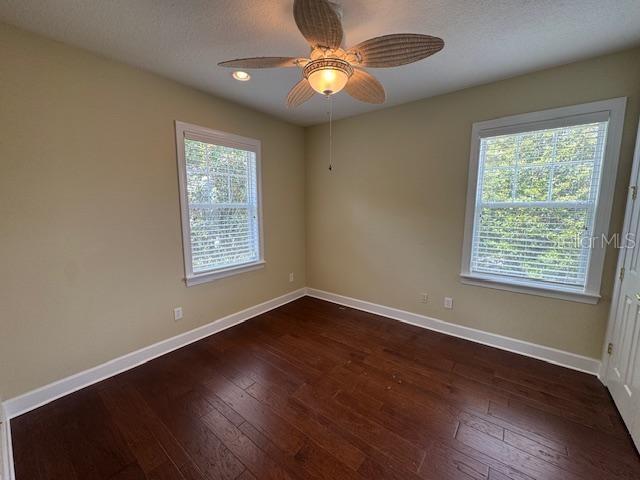1442 Stickley Avenue Celebration, FL 34747 - Photo 30 of 46 a view of an empty room with window and wooden floor