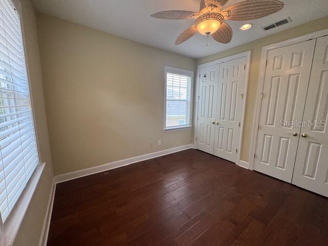 1442 Stickley Avenue Celebration, FL 34747 - Photo 31 of 46 an empty room with wooden floor and windows