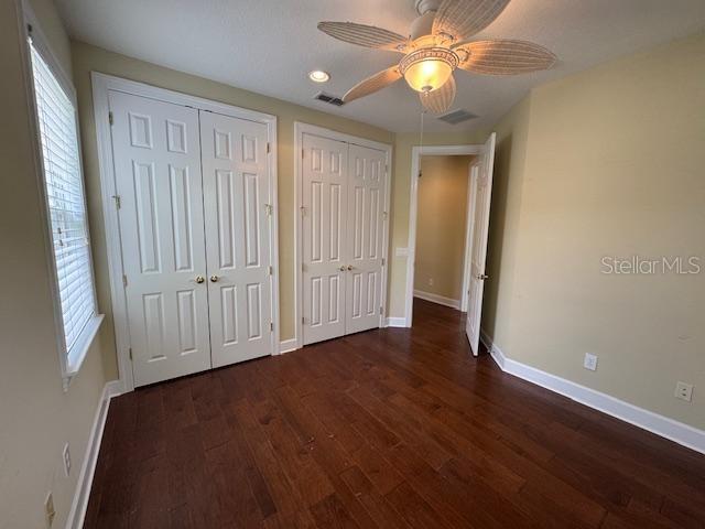 1442 Stickley Avenue Celebration, FL 34747 - Photo 32 of 46 an empty room with wooden floor fan and windows