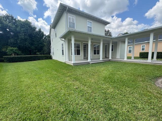 1442 Stickley Avenue Celebration, FL 34747 - Photo 37 of 46 a view of a white house with a big yard and large trees