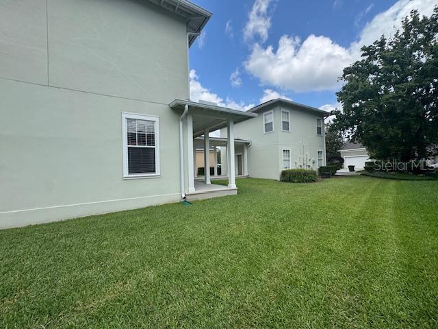 1442 Stickley Avenue Celebration, FL 34747 - Photo 38 of 46 a view of a house with a big yard and large tree