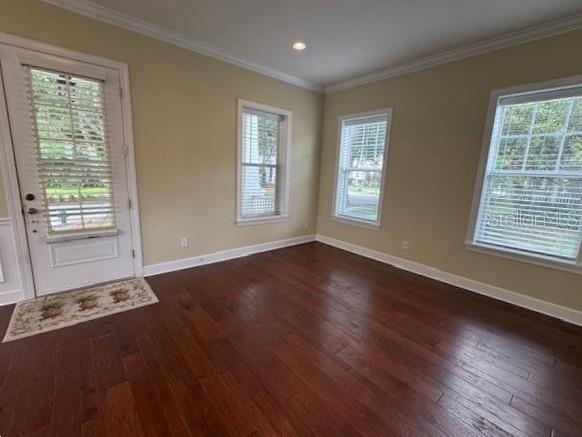 1442 Stickley Avenue Celebration, FL 34747 - Photo 6 of 46 a view of an empty room with wooden floor and a window