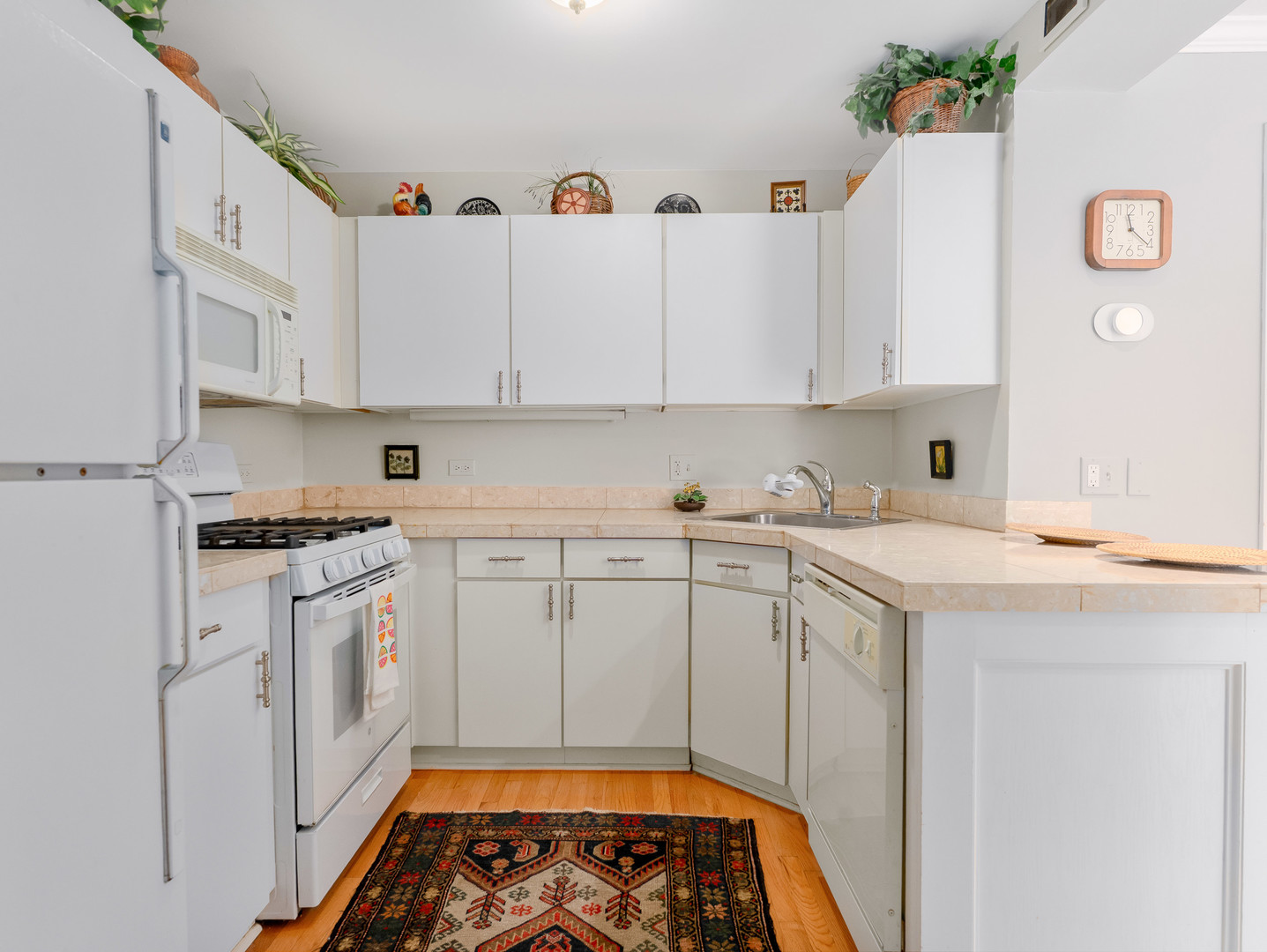 471 River Bend Road, Unit 107 Naperville, IL 60540 - Photo 11 of 31 a kitchen with cabinets appliances and a window