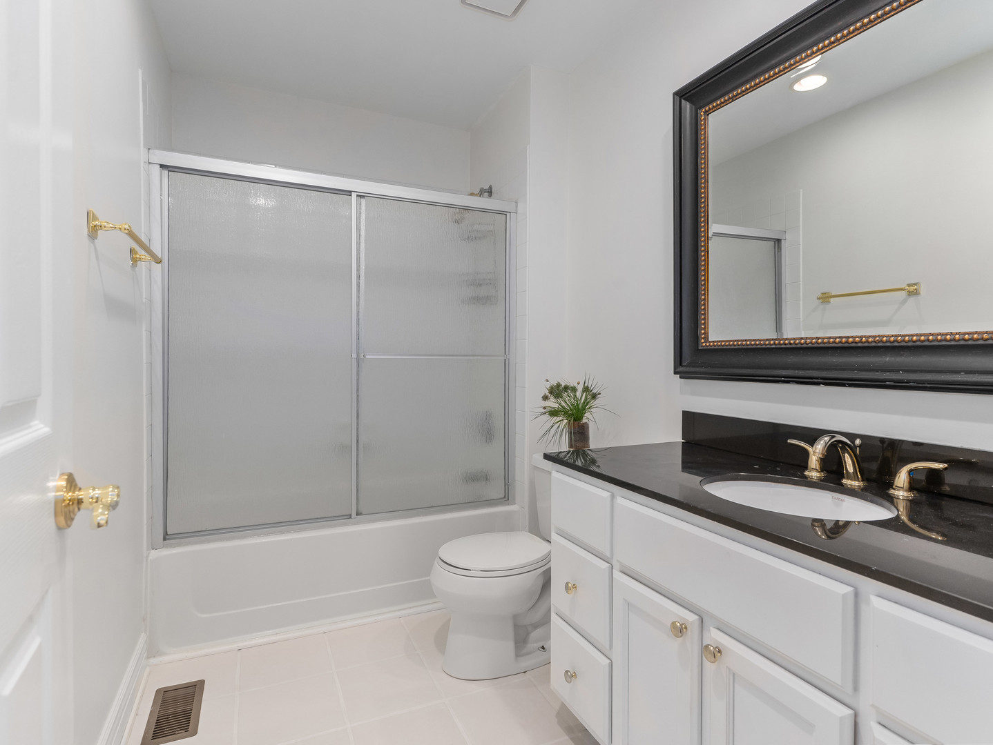 471 River Bend Road, Unit 107 Naperville, IL 60540 - Photo 23 of 31 a bathroom with a granite countertop sink a toilet a mirror and shower