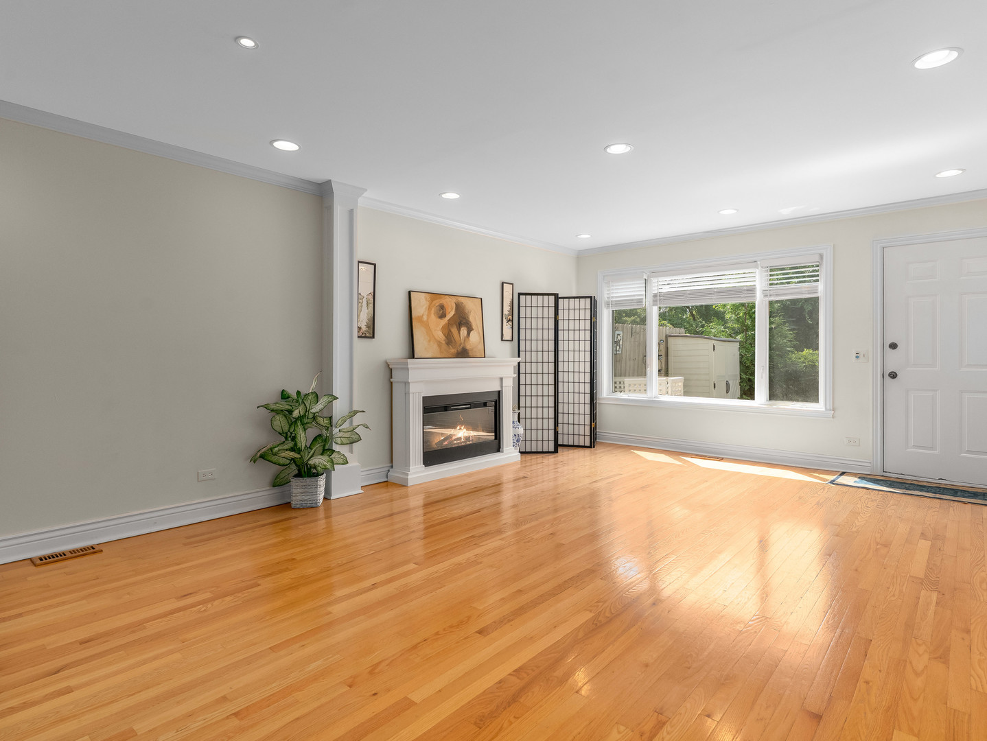 471 River Bend Road, Unit 107 Naperville, IL 60540 - Photo 8 of 31 a view of an empty room with a window and wooden floor