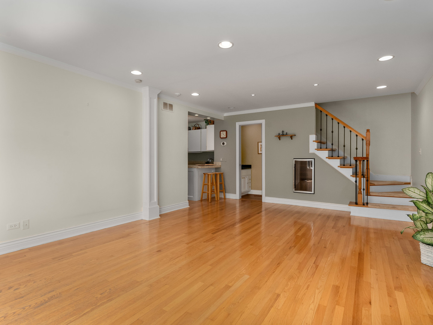 471 River Bend Road, Unit 107 Naperville, IL 60540 - Photo 9 of 31 a view of a hall with wooden floor and a kitchen