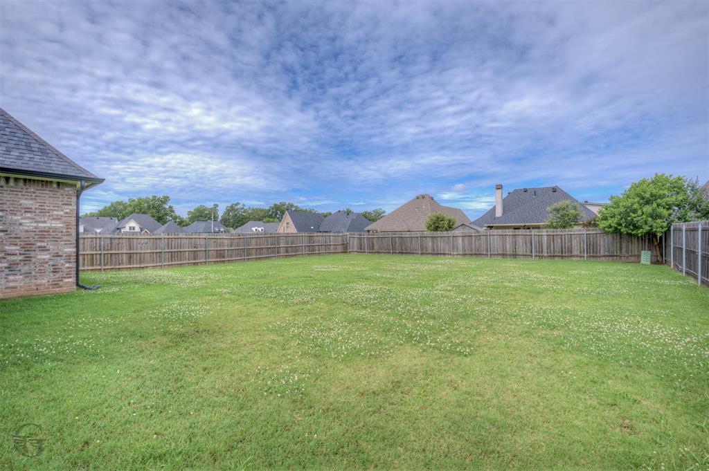 605 Meridian Way Benton, LA 71006 - Photo 28 of 29 Expansive grassy yard with a wooden privacy fence