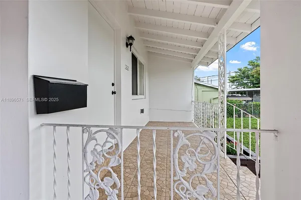 a front view of a house with wooden floor and windows