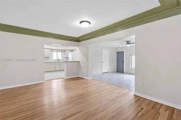 a kitchen with sink a microwave and refrigerator