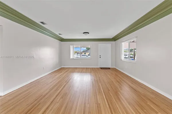 a kitchen with a refrigerator sink and cabinets