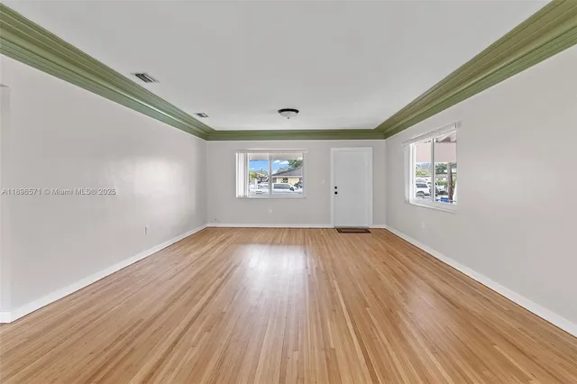 a kitchen with a refrigerator sink and cabinets