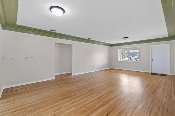 a kitchen with granite countertop white cabinets and stainless steel appliances