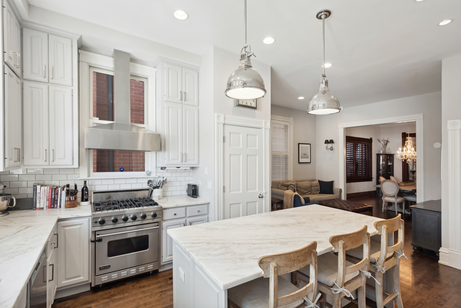 2511 North Burling Street Chicago, IL 60614 - Photo 11 of 37 a large kitchen with kitchen island a stove a sink a center island and stainless steel appliances