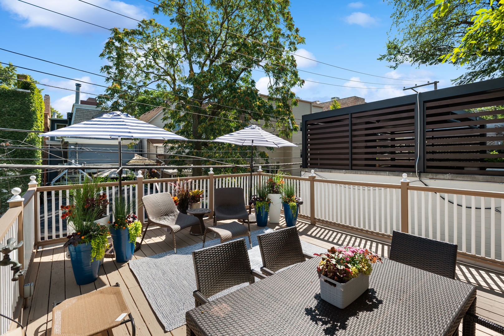 2511 North Burling Street Chicago, IL 60614 - Photo 29 of 37 a patio with wooden floor a barbeque oven and outdoor seating