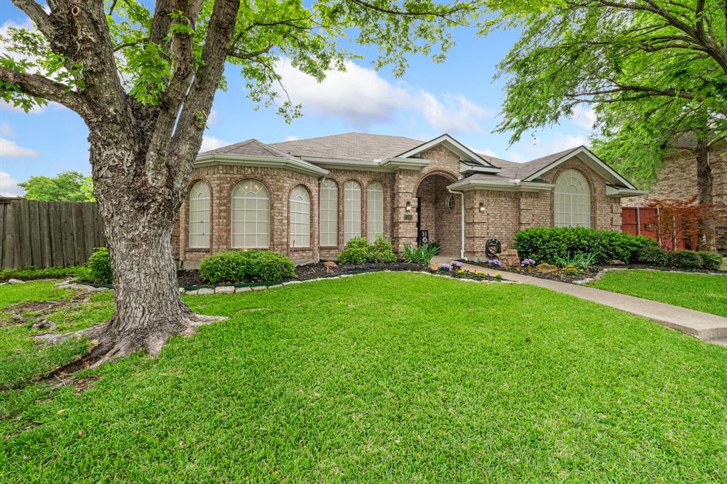 2302 Randi Road Rowlett, TX 75088 - Photo 2 of 33 a front view of a house with a garden and tree