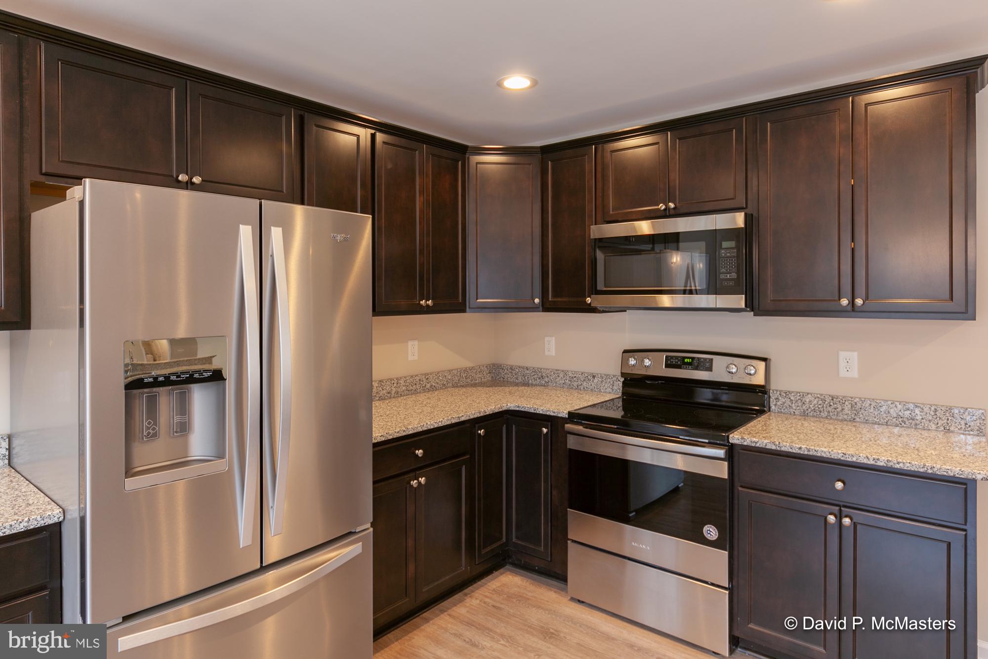 194 Dimension Road Inwood, WV 25428 - Photo 12 of 26 a kitchen with a refrigerator stove and microwave
