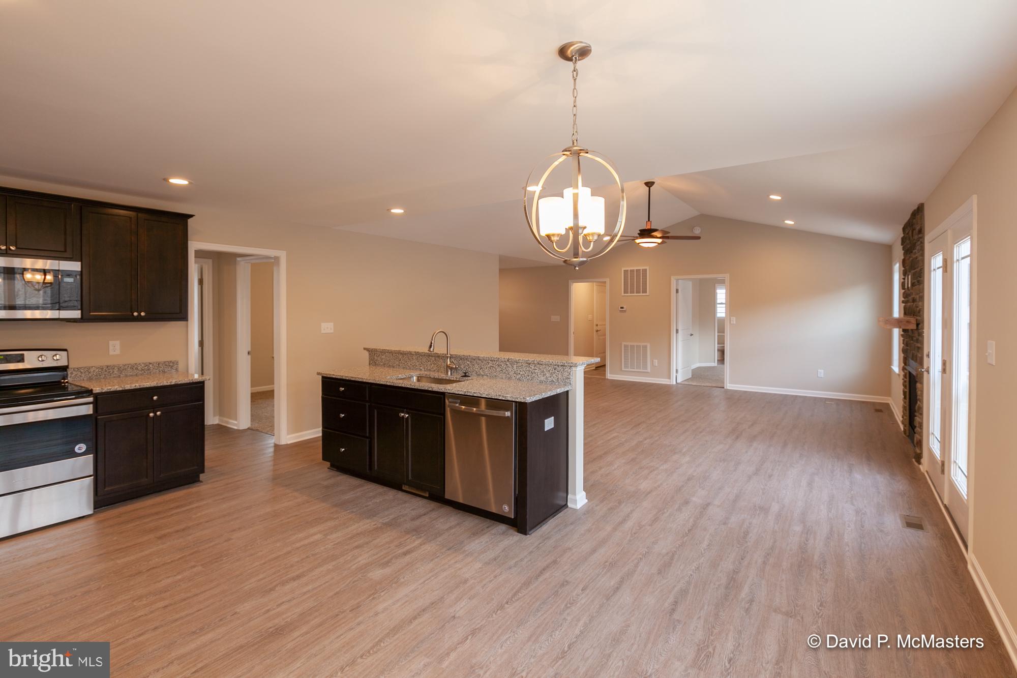 194 Dimension Road Inwood, WV 25428 - Photo 13 of 26 a large kitchen with stainless steel appliances granite countertop a large counter top and wooden floors