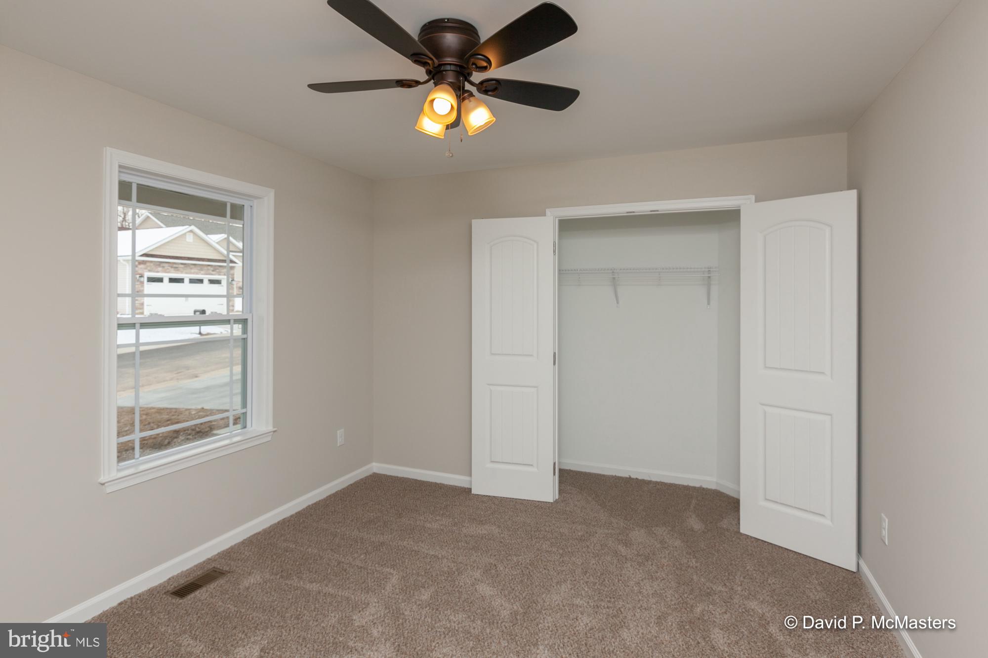 194 Dimension Road Inwood, WV 25428 - Photo 20 of 26 an empty room with windows and fan