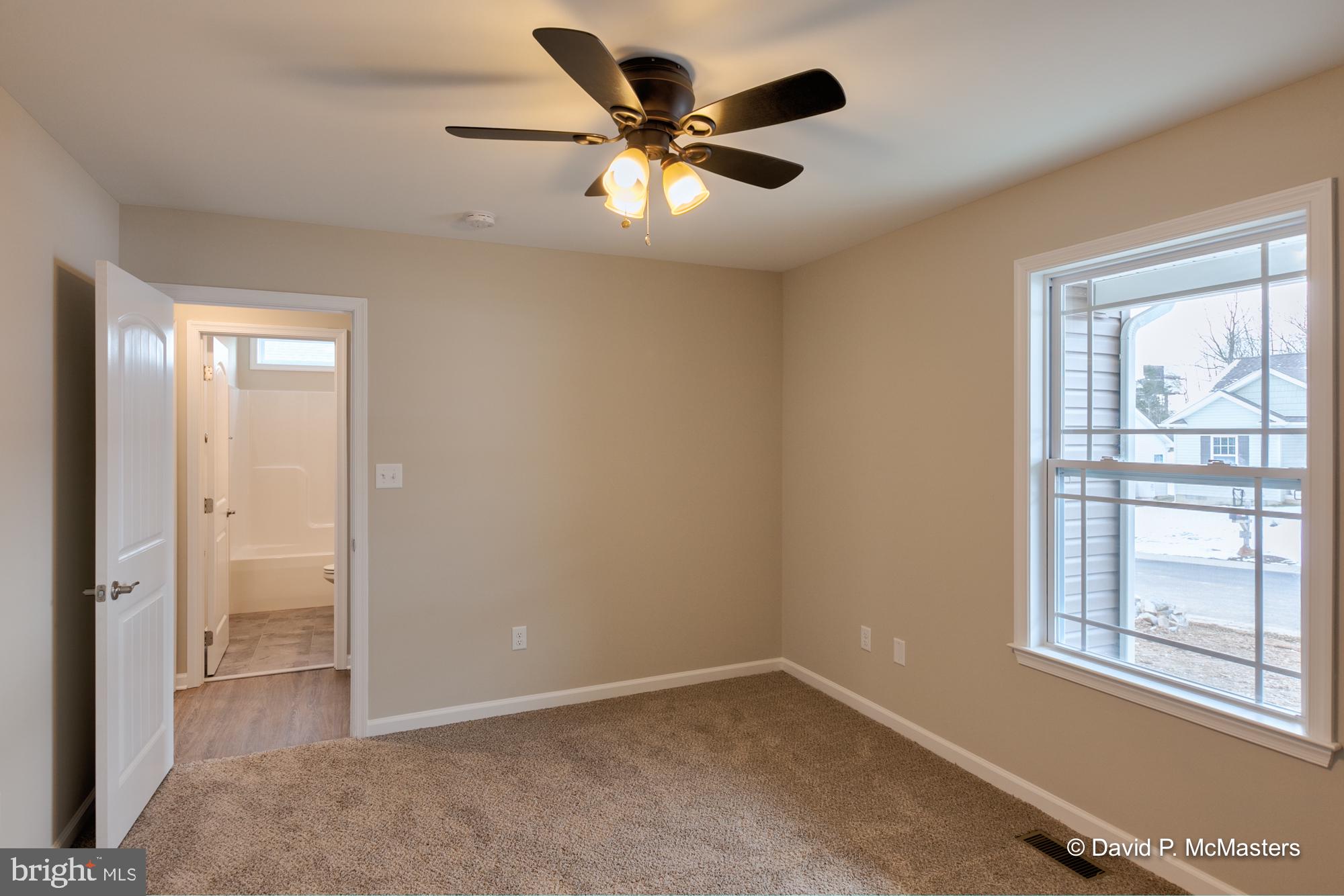 194 Dimension Road Inwood, WV 25428 - Photo 21 of 26 an empty room with windows and a ceiling fan