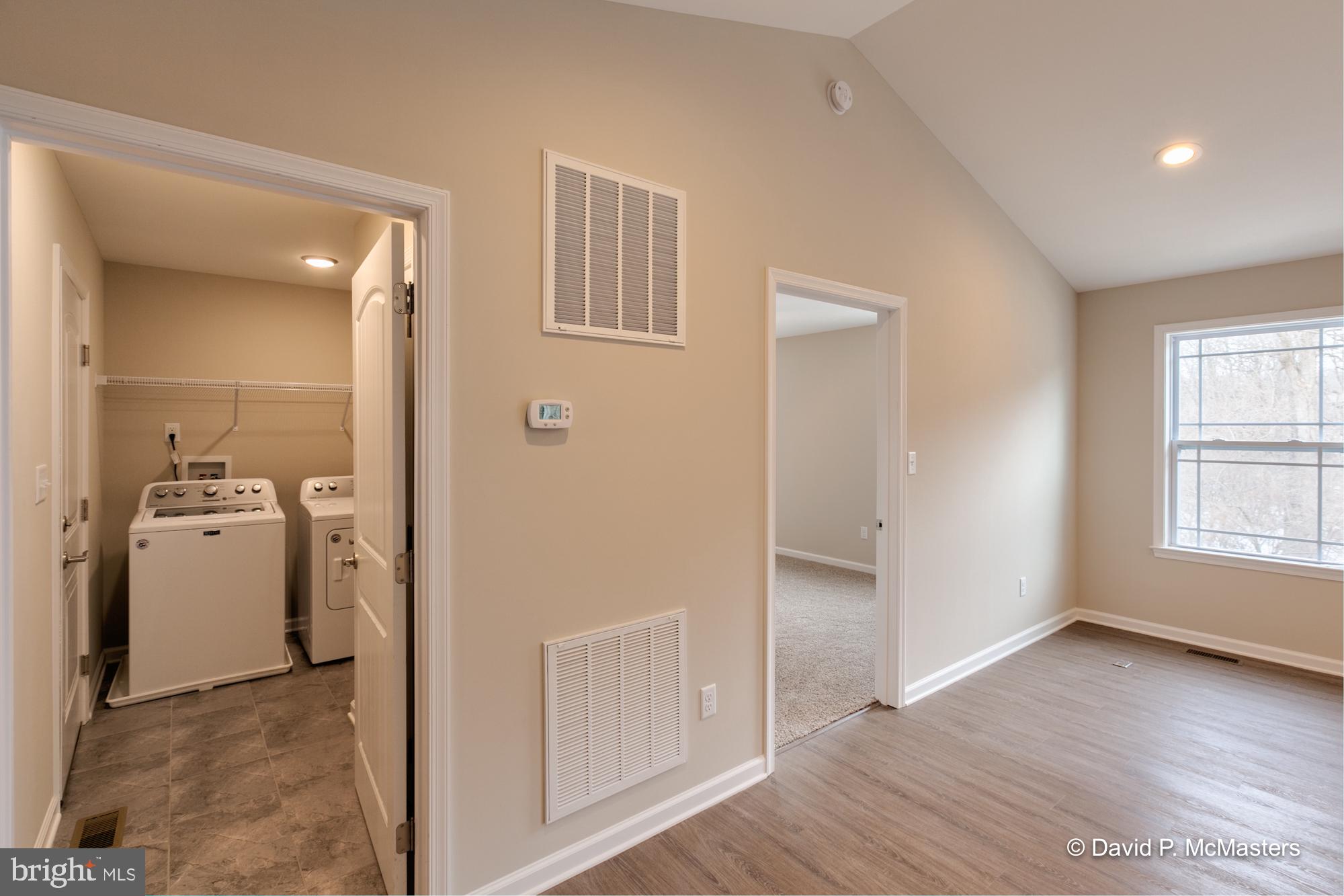 194 Dimension Road Inwood, WV 25428 - Photo 22 of 26 wooden floor in an empty room and a bathroom