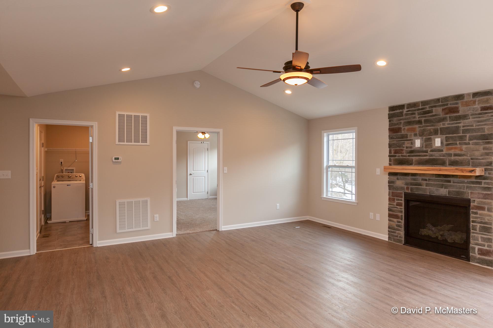 194 Dimension Road Inwood, WV 25428 - Photo 10 of 26 a view of a livingroom with a ceiling fan window and a fireplace
