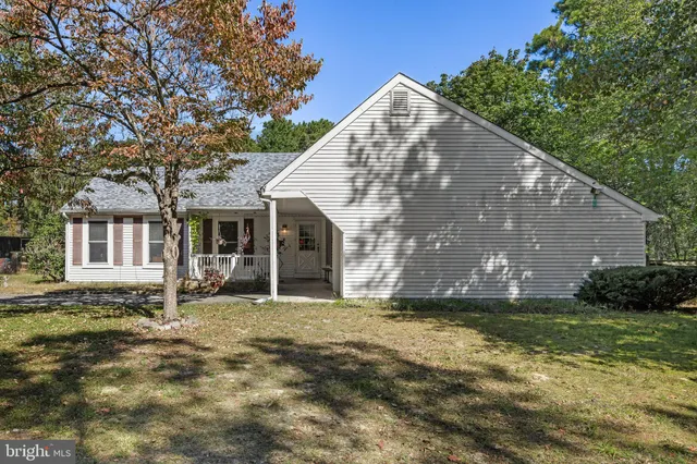 a view of a porch with a table and chairs