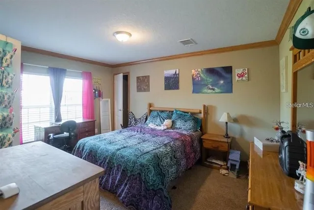 a spacious bedroom with two beds and a desk