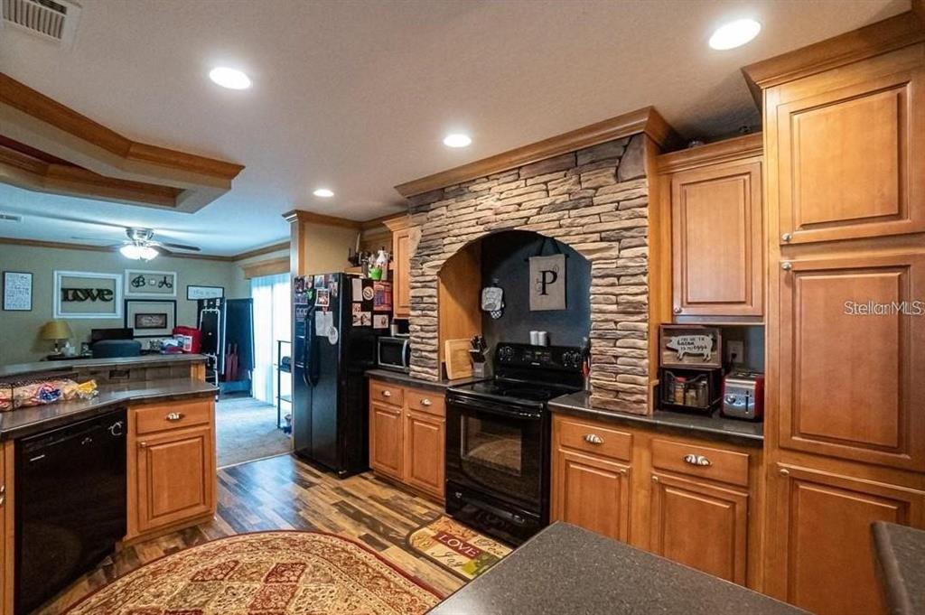 4441 Anderson Road Kissimmee, FL 34746 - Photo 6 of 20 a kitchen with stainless steel appliances granite countertop a stove and a refrigerator