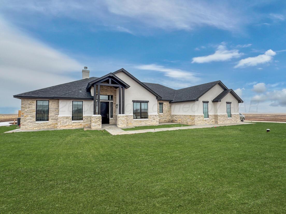 a front view of house with yard and green space