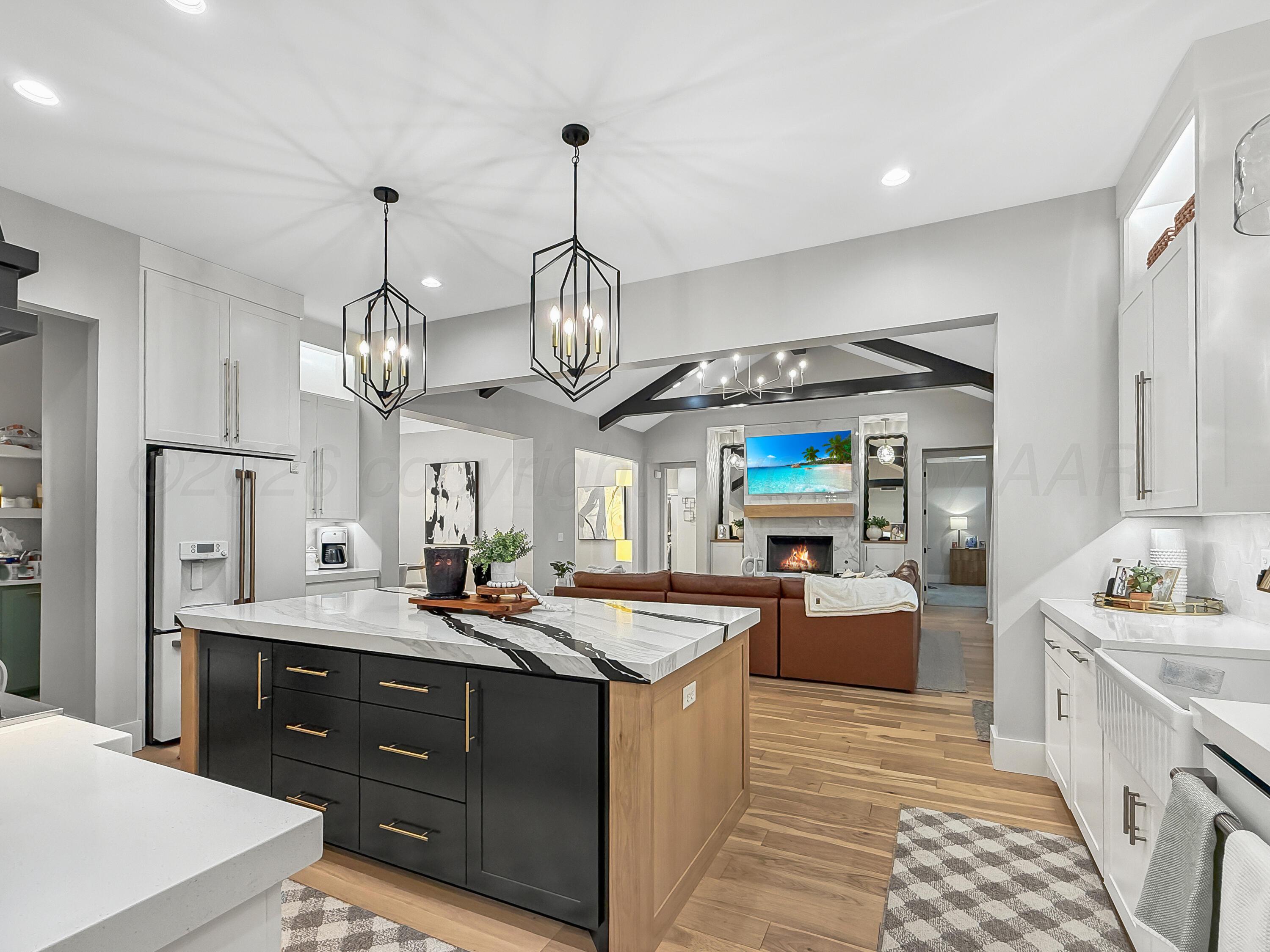 3701 Longhorn Springs Road Amarillo, TX 79119 - Photo 12 of 48 a large kitchen with a counter space a sink appliances and living room view