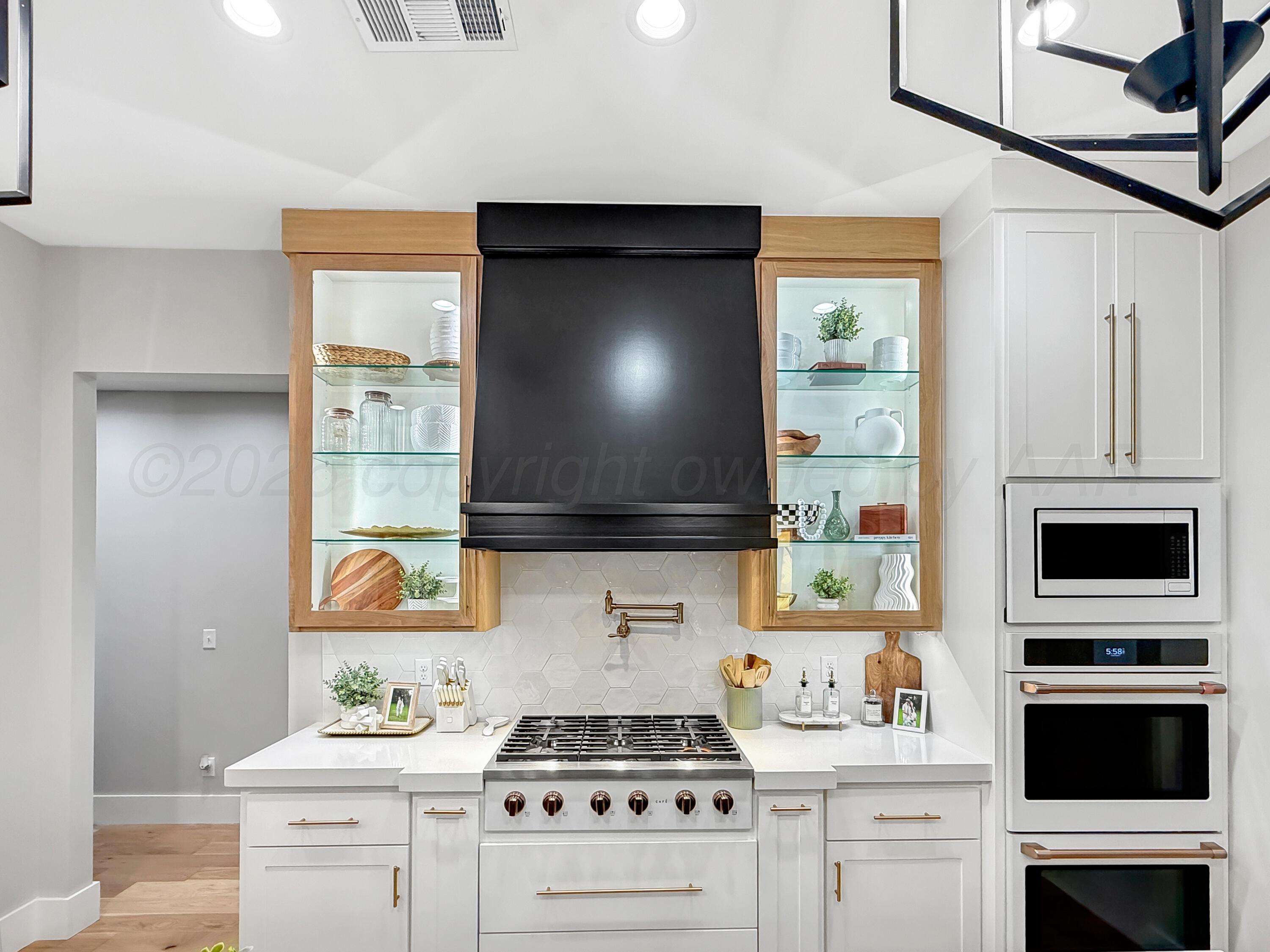 3701 Longhorn Springs Road Amarillo, TX 79119 - Photo 14 of 48 a kitchen with a stove and a microwave
