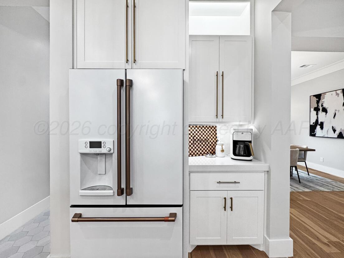 3701 Longhorn Springs Road Amarillo, TX 79119 - Photo 16 of 48 a kitchen with white cabinets and white appliances