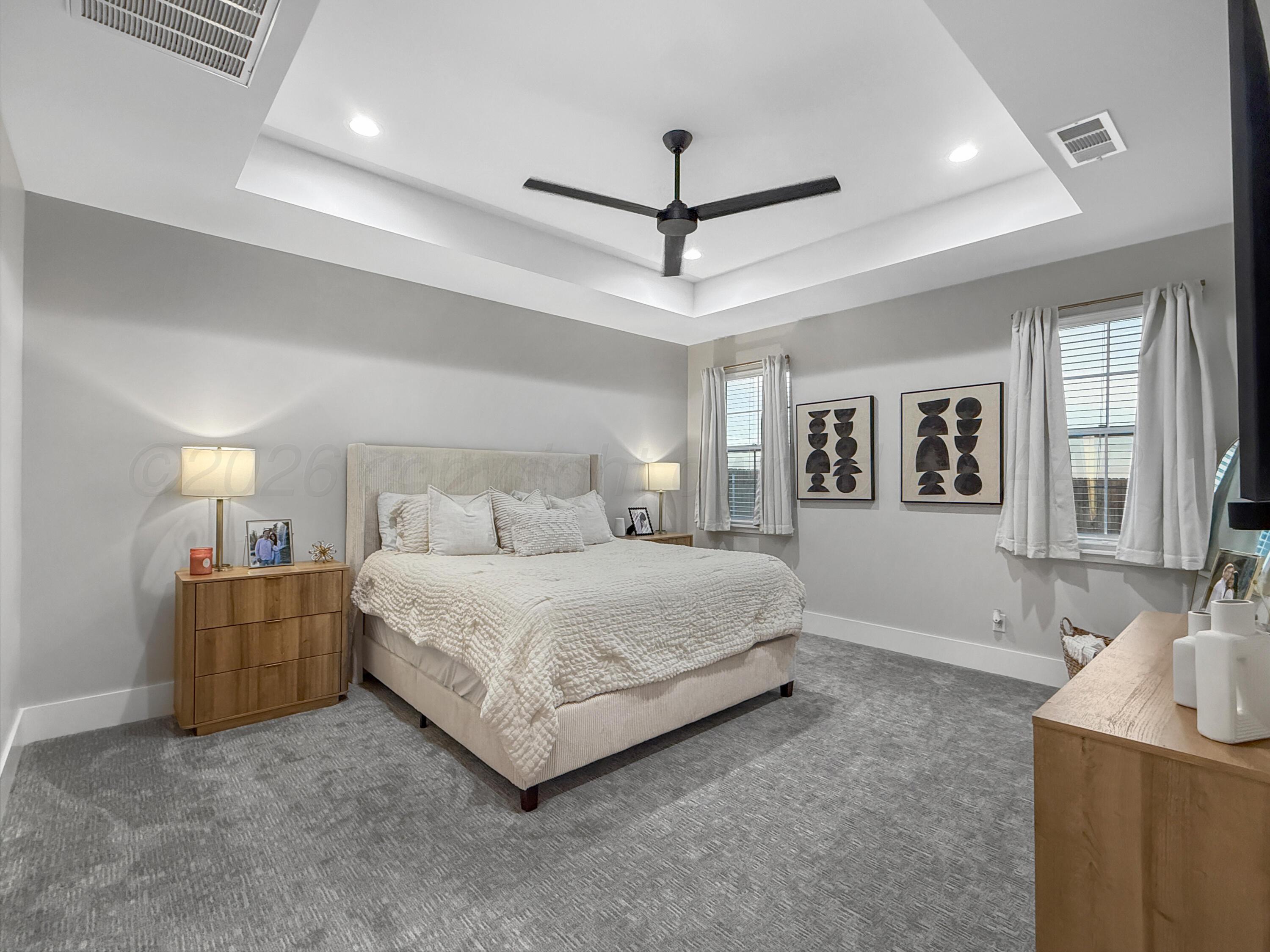 3701 Longhorn Springs Road Amarillo, TX 79119 - Photo 19 of 48 a spacious bedroom with a bed and a couch