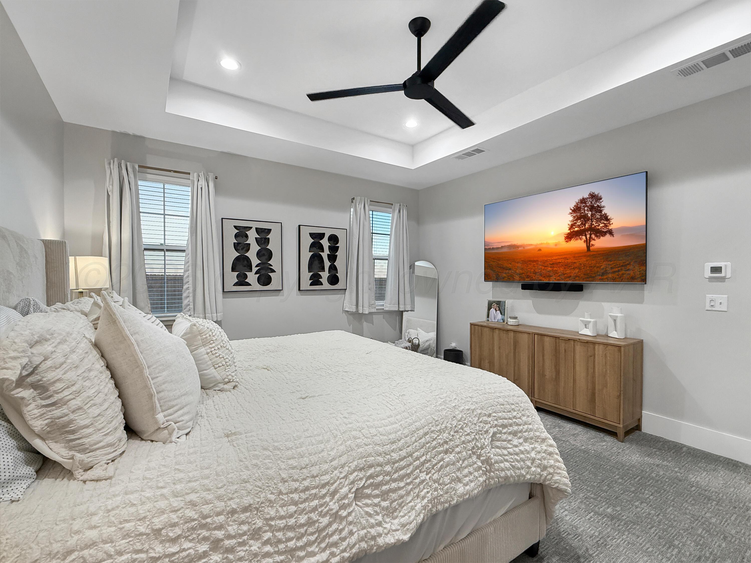 3701 Longhorn Springs Road Amarillo, TX 79119 - Photo 20 of 48 a bedroom with a bed and a flat screen tv