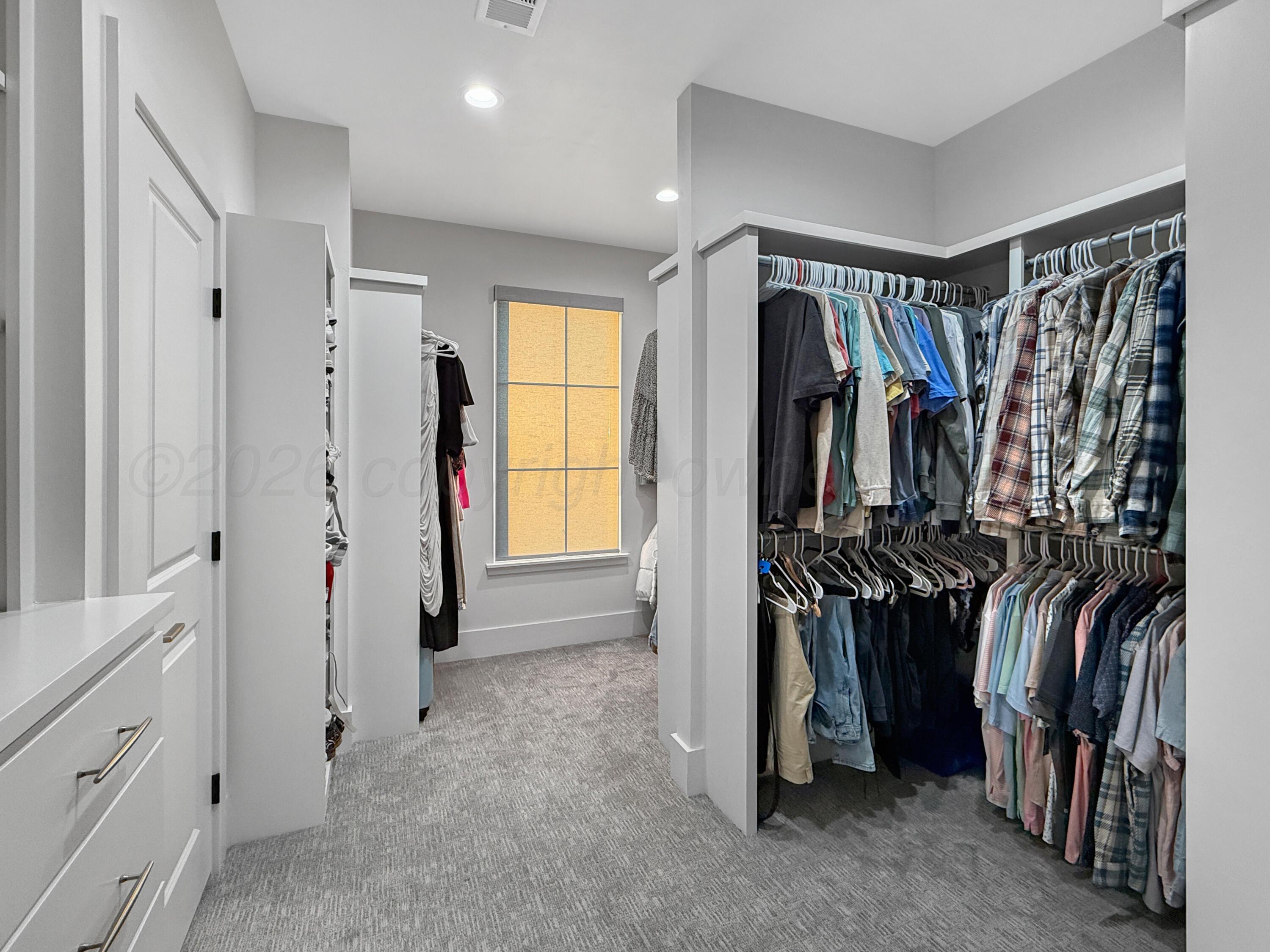 3701 Longhorn Springs Road Amarillo, TX 79119 - Photo 24 of 48 a view of walk in closet with clothes and shoes