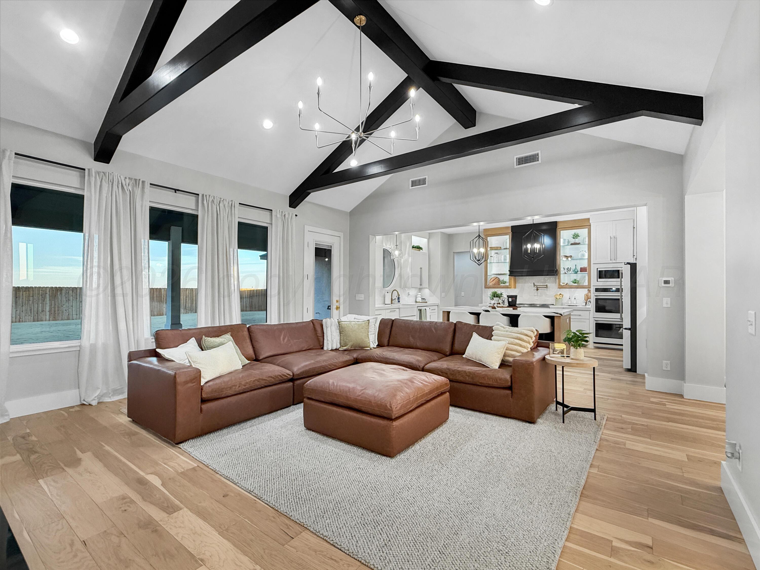 3701 Longhorn Springs Road Amarillo, TX 79119 - Photo 7 of 48 a living room with furniture and a flat screen tv