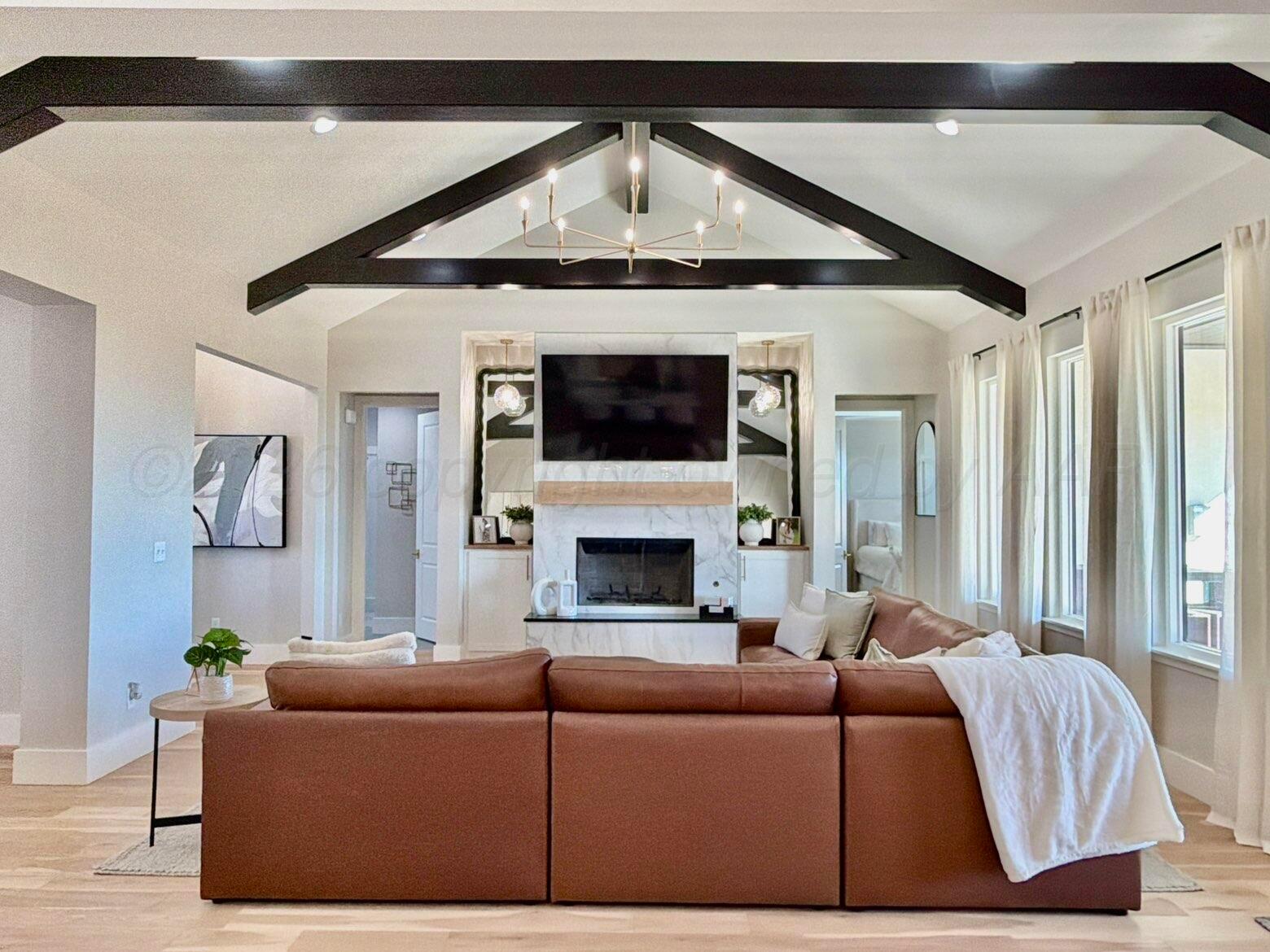 3701 Longhorn Springs Road Amarillo, TX 79119 - Photo 8 of 48 a living room with furniture and a fireplace