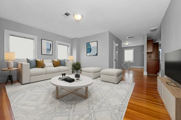 a living room with furniture and a flat screen tv