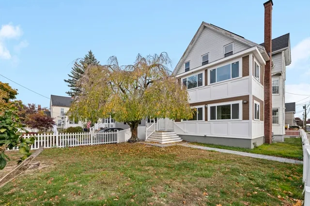 a front view of a house with a garden and plants