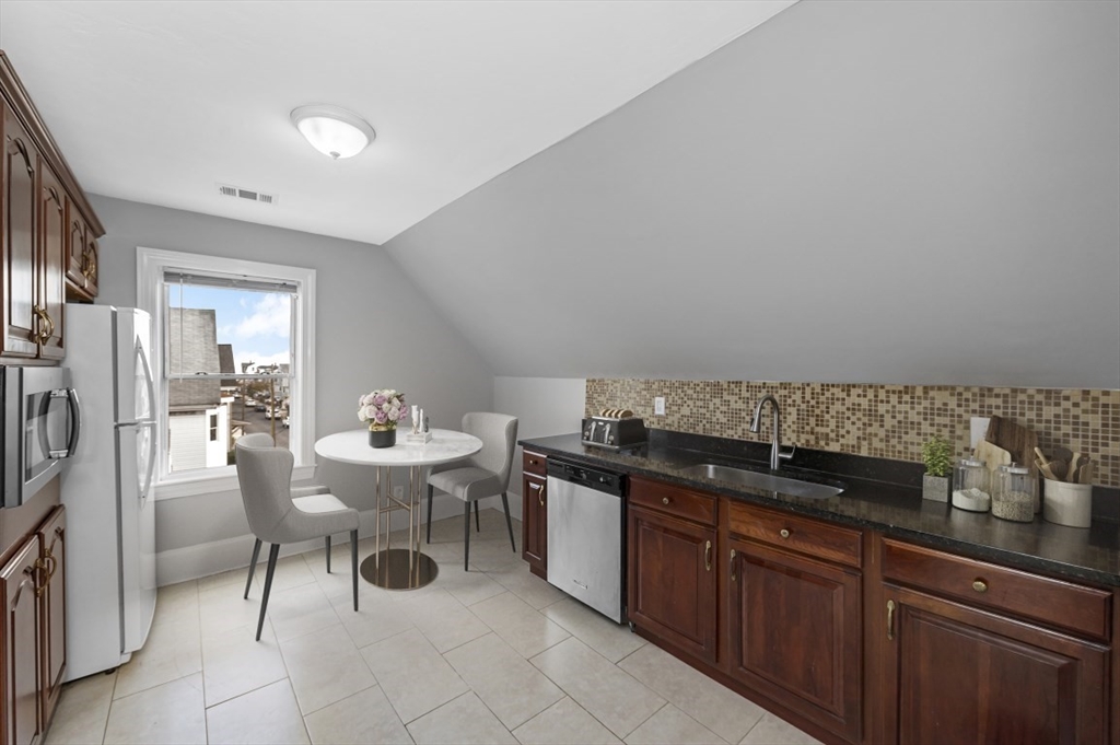 129 Lynnway, Unit 3 Revere, MA 02151 - Photo 3 of 14 a kitchen with a sink and chairs