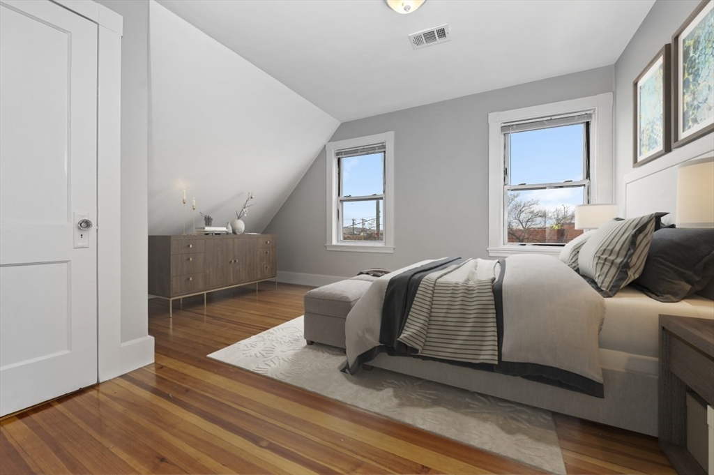 129 Lynnway, Unit 3 Revere, MA 02151 - Photo 6 of 14 a bedroom with a bed and wooden floor