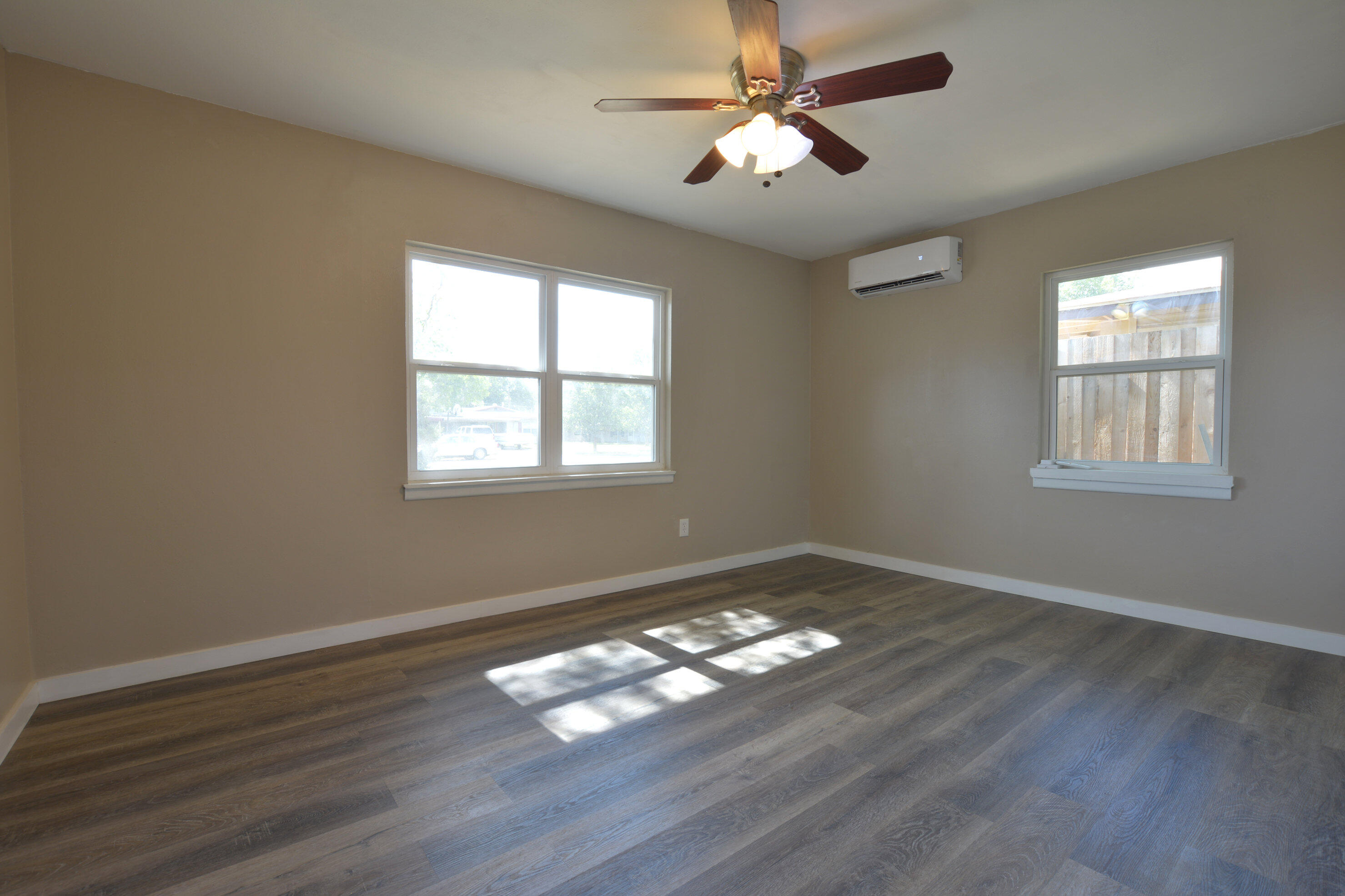 4608 Detroit Avenue Lubbock, TX 79413 - Photo 15 of 20 a view of empty room with wooden floor and fan