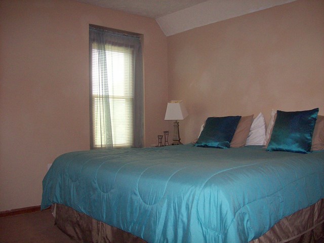 396 Buck Road Gray, GA 31032 - Photo 15 of 36 a large bed sitting in a bedroom next to a window