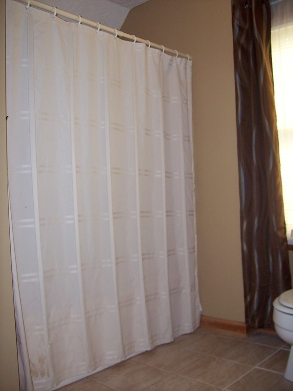 396 Buck Road Gray, GA 31032 - Photo 18 of 36 a view of a bathroom with a shower curtain and sink