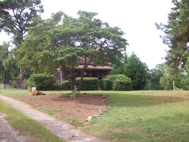 396 Buck Road Gray, GA 31032 - Photo 35 of 36 a backyard of a house with a parked tree